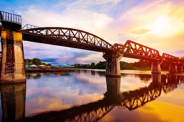 Foto op Canvas colorful twilight time of river khaw bridge in kanchanaburi most popular world war II history traveling destination in western of thailand © stockphoto mania