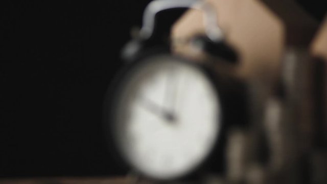 dolly zoom black alarmclock and house paper cardboard on wooden floor