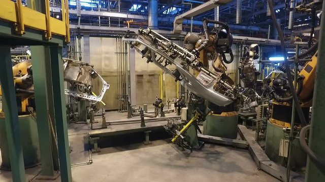 robotic welding in car factory, making car body, car wing, inside workshop