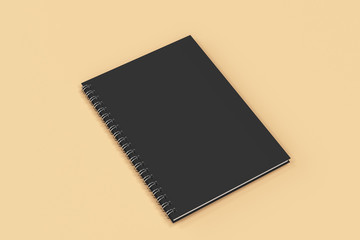 Closed notebook spiral bound on orange background