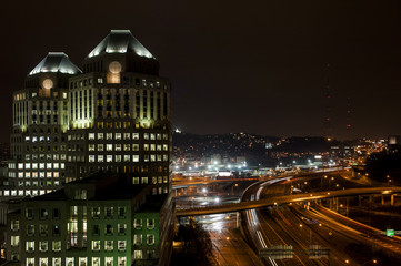 Post Modern Skyscraper Overlooking Interstate Highway at Night