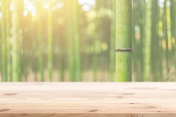 Gordijnen Houten voorgrond met vervaging bamboe hout bos achtergrondontwerp voor weergave van natuurproducten © Quality Stock Arts