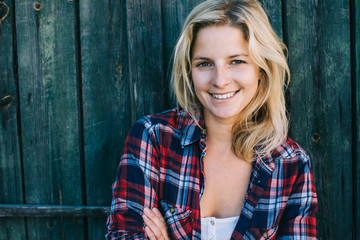 Beautiful portrait of young woman against wooden background