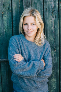 Young woman in warm clothes looking at camera.  Autumn fashion concept.