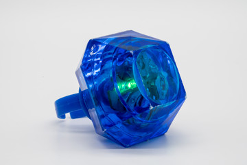 Blue LED plastic diamond ring toy isolated on white