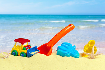 colorful beach toys on sand