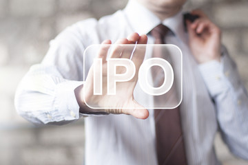 Businessman presses button Initial Public Offering online ipo
