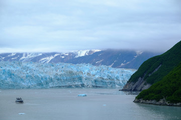 Small boat in front of the Hubbard Glacier in Alaska