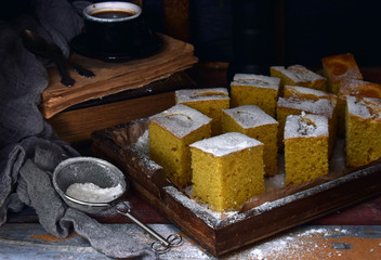 Homemade corn cake with tangerines on dark background. Traditional Brazilian sweet pie. Cornbread. Style Dark Moody