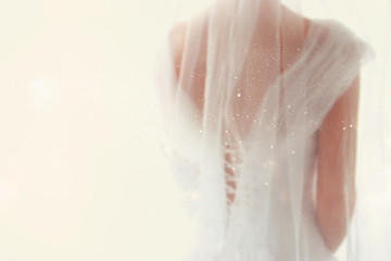Fototapeta premium Dreamy abstract and blurry background of beautiful bride with wedding dress, from behind