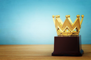 image of golden crown award over wooden table