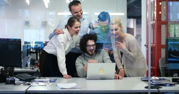 business peope discussing new ideas in fron of computer in cool statup office