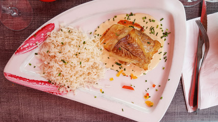 white triangle plate in the restaurant with fish and rice