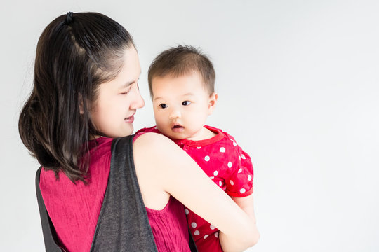 Portrait of happy asian mother hugging her cute baby