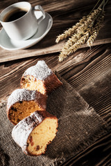 pie on bedding with the cup of coffee on a background a wooden table
