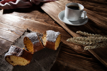 pie on bedding with the cup of coffee on a background a wooden table
