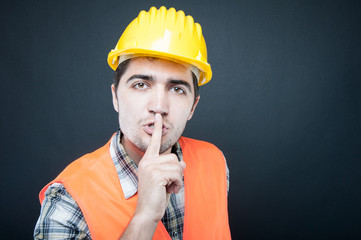 Constructor wearing equipment showing silence gesture