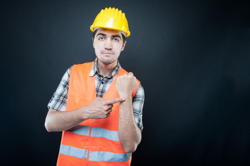 Constructor wearing equipment showing time gesture