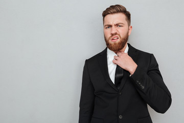 Displeased bearded man in suit