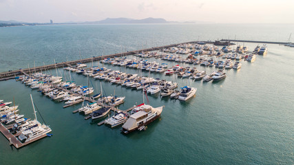 Fototapeta premium Pier speedboat. A marina lot. This is usually the most popular tourist attractions on the beach.Yacht and sailboat is moored at the quay.Aerial view by drone.Top view.