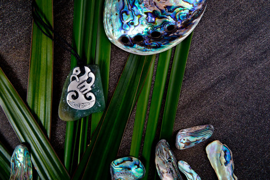New Zealand - Maori themed objects - metal and greenstone pendant with flax leaves and abalone shells