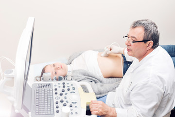 Fototapeta na wymiar Adult female patient going through abdomen ultrasound at private clinic.
