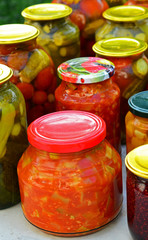 Homemade canned vegetables and jam in glass jars