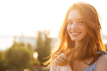Smiling young redhead girl with long hair