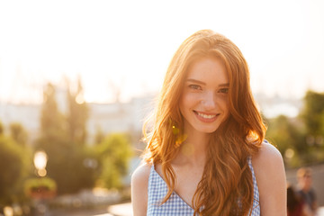Happy pretty redhead girl with long hair - Powered by Adobe
