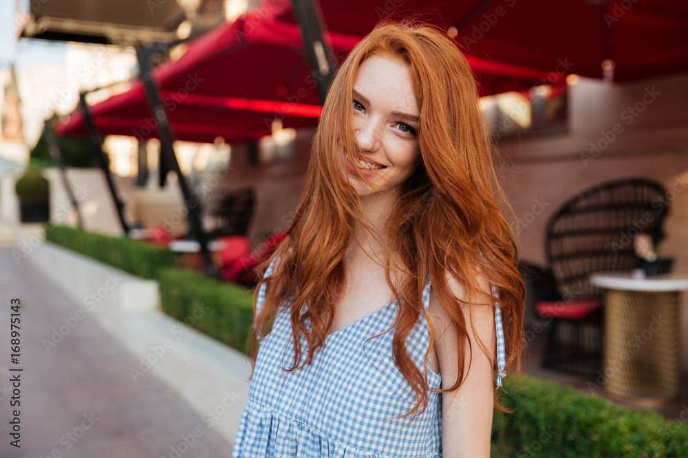 Canvas Prints smiling pretty redhead girl with long hair looking at camera