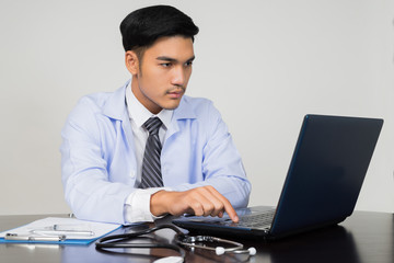 medical doctor working with laptop computer on white background