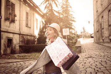 Naklejka premium Happy woman in shopping. Young woman happy shopping street
