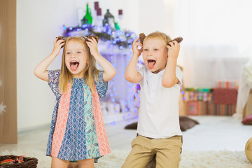 Brother and sister pretending to be dogs pinecones as puppy ears