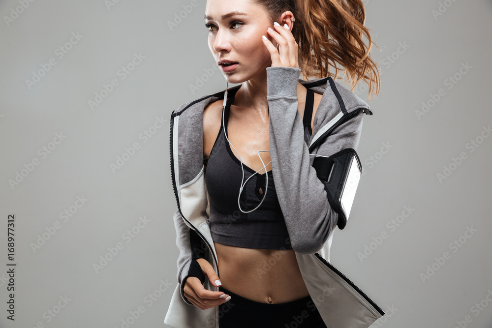 Sticker Cropped image of a pretty young fitness woman in sportswear