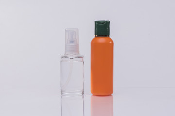 Hair Serum in a glass bottle and orange bottle