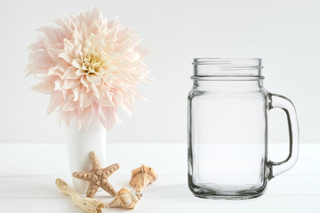 Floral mock-up of a mason jar, next to flower arrangement, perfect for businesses who sell decals, vinyl stickers, just overlay your design