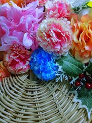 Close up colorful flowers in wooden basket