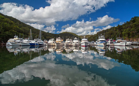 Luxury cruisers rest in their berths in Bobbin Head Marina on the Hawkesbury River near Sydney. The marina is situated in the Kuring-gai Chase national park.
