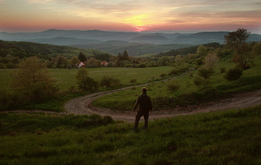 Man in Green Landscape in Sunset