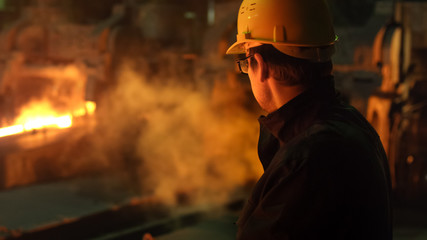 Portrait of Heavy Industry Technician in Hard Hat in Foundry. Industrial Environment.