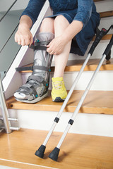 women sitting on stairs with broken leg