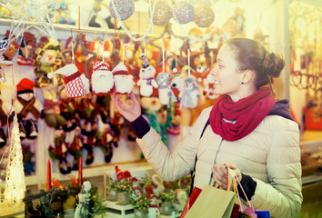 Woman at Christmas fair in evening.