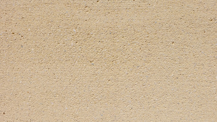 Background of sandy beige or light brown colored wall.