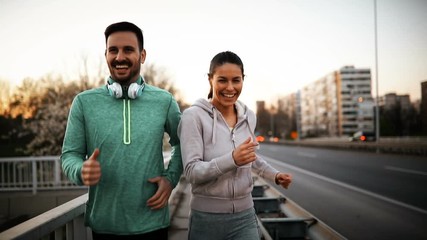 Happy friends and sports people jogging and running outdoor - Powered by Adobe