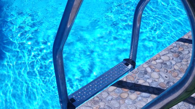 Ladder to the pool, reflection on the water