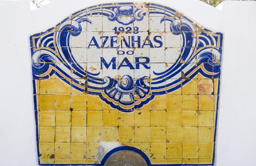 Blue and yellow vintage portuguese tiles (azulejos) with Azenhas do Mar (village in Sintra) written on them
