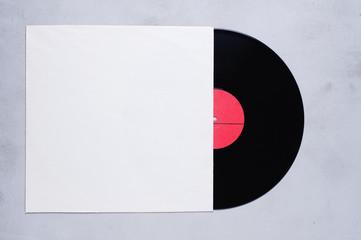 Vinyl record with red label in white cover