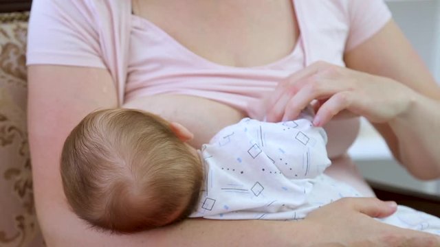 process of breastfeeding the child