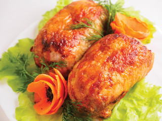 Roll chicken with greens and vegetables on the plate