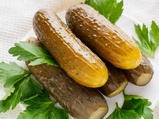 pickles with greens on the white plate